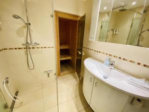 a bathroom with a sink and a shower at Ferienhaus Maria in Warnemünde +22 photos