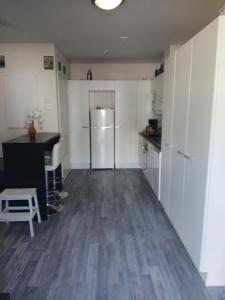 a kitchen with a refrigerator and a table in it at Cozy Studio Järvenpää in Järvenpää