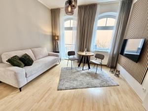 a living room with a couch and a table at Traumstrand, am Kurpark in Warnemünde +11 photos