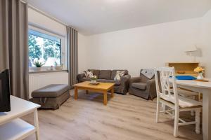 a living room with a couch and a table at Ferienwohnung Bahlmann in Garrel