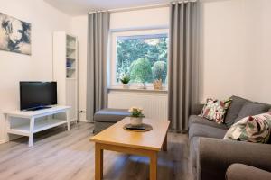 a living room with a couch and a tv at Ferienwohnung Bahlmann in Garrel