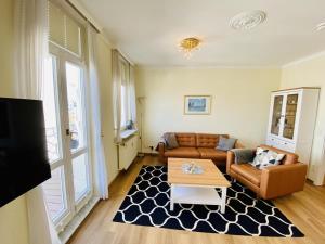 a living room with a couch and a coffee table at Ostseeliebe, direkt an der Promenade in Warnemünde