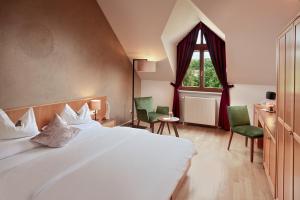 a bedroom with a large bed and a window at Ayurveda Resort MANDIRA in Bad Waltersdorf