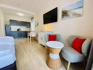 a living room with a couch and a table at Landhaus Immenbarg, Lobby in Warnemünde