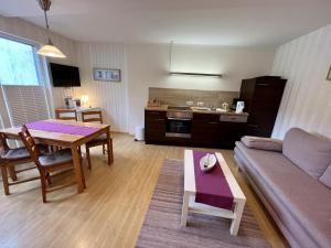 a living room with a couch and a table at Haus Juliane, Lichtblick in Warnemünde