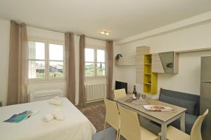 a kitchen and dining room with a table and chairs at Corte Fasanella 33 in Toscolano Maderno