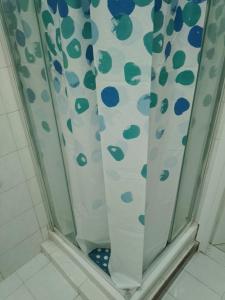 a shower with a shower curtain in a bathroom at Casa Stella Marina in Anzio