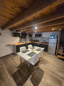a kitchen and dining room with a table and chairs at Le calme in La Souterraine