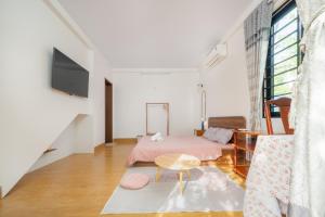 a living room with a bed and a table at Live like a local Homestay in Ấp Tư Tây +28 photos