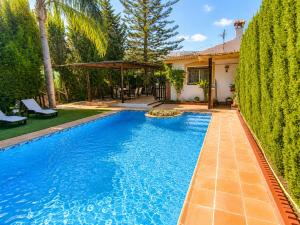 a swimming pool in the backyard of a house at Velez Nazari Cortijo Azud in Vélez de Benaudalla