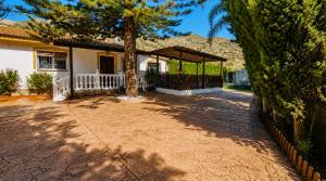 a house with a tree in the yard at Velez Nazari Cortijo Azud in Vélez de Benaudalla
