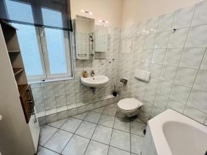 a white bathroom with a sink and a toilet at Haus Juliane, Neptun in Warnemünde +8 photos