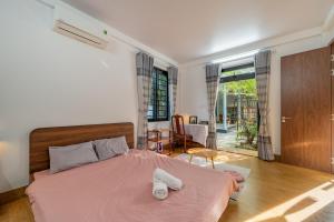 a bedroom with a bed with two towels on it at Live like a local Homestay in Ấp Tư Tây