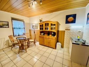 a kitchen with a table and a dining room at Ferienhaus Segelboot in Warnemünde
