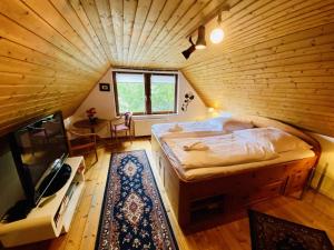 a bedroom with a bed in a wooden room at Ferienhaus Segelboot in Warnemünde