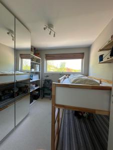 a bedroom with a bed and a large mirror at Moderne enebolig, sentralt in Oslo