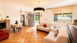 a living room with a couch and a table at Velez Nazari Cortijo Azud in Vélez de Benaudalla