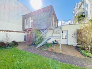 a house with a staircase leading up to a house at Haus Juliane, Seepferdchen in Warnemünde