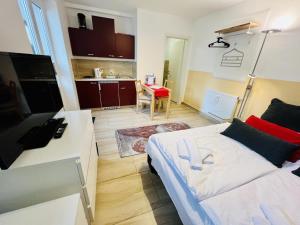 a small living room with a bed and a kitchen at Haus Juliane, Seepferdchen in Warnemünde