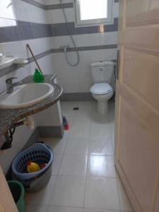 a small bathroom with a sink and a toilet at Dar chat in Kelibia