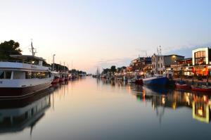 a group of boats are docked in a river at Haus Juliane, Strandliebe in Warnemünde