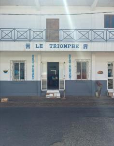 a woman standing in front of a building with the front entrance at LE Triomphe in Antsiranana