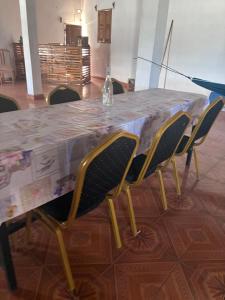 a table with chairs and a bottle on top of it at LE Triomphe in Antsiranana