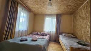 a bedroom with two twin beds and a window at Elo's Guesthouse in Iprari