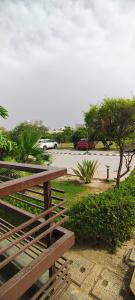 a wooden bench in a park with a parking lot at krishna kunj stay in Mathura