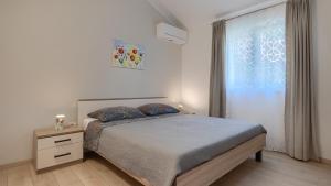 a bedroom with a bed and a window at Villa MA by Villas Guide in Vodnjan +33 photos
