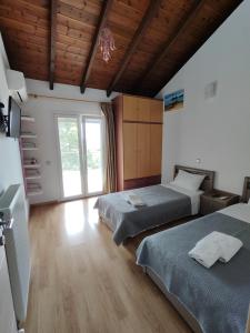 a bedroom with two beds and a window at Oasis Exclusive in Parga