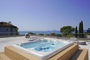 a hot tub sitting on top of a patio at Corte Fasanella 25 - Gardagate in Toscolano Maderno