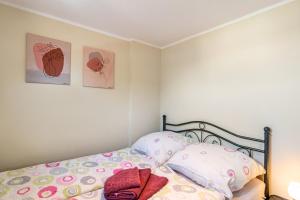 a bedroom with a bed and two pictures on the wall at Ferienwohnung Grodenblick in Hooksiel