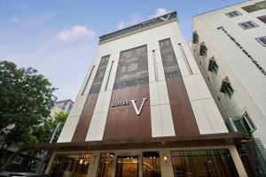 a tall building with a v sign on it at Hotel V Kondapur in Hyderabad