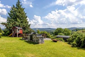 a backyard with a playground and a tree at Bergpanorama Ruhla in Ruhla