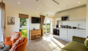 a kitchen and living room with a couch and chairs at Scald Law in Penicuik