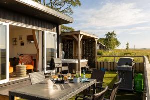 a patio with a table and chairs and a grill at Scald Law in Penicuik