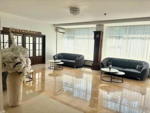a lobby with couches and tables in a building at Hotel Parc in Craiova