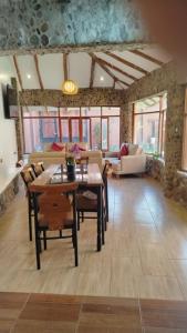 a living room with a table and chairs at Intikilla House in Cusco