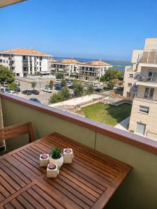a table on a balcony with a view of the ocean at Guest House 36 private parking in Orbetello