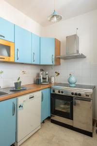 a kitchen with blue cabinets and a stove at Il Salento di Socrate e Socrata in Ugento