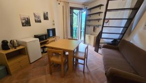 a small living room with a table and a couch at Il rifugio della Presolana in Castione della Presolana +15 photos