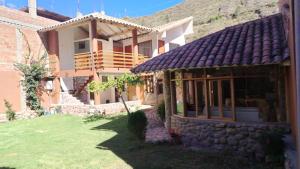 a house with a stone building with a yard at Intikilla House in Cusco