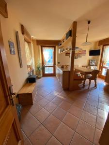 a kitchen with a table and a dining room at La Casa del SEI SERIO in Pieve di Cadore