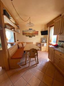 a living room with a table and a couch at La Casa del SEI SERIO in Pieve di Cadore