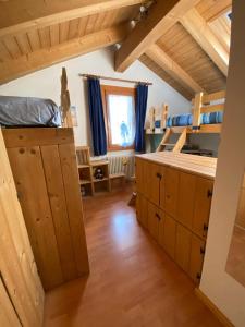 a room with bunk beds in a house at La Casa del SEI SERIO in Pieve di Cadore