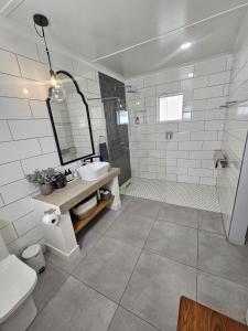 a bathroom with a sink and a shower and a toilet at Rosa's Self-catering in Springbok +35 photos
