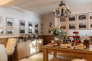 a dining room with a table with food on it at Willa Rajka in Zakopane