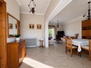 a living room with a bed and a dining room at Dimitris house in Parga