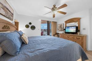 a bedroom with a bed and a flat screen tv at Buena Vista Condominiums in Gulf Shores